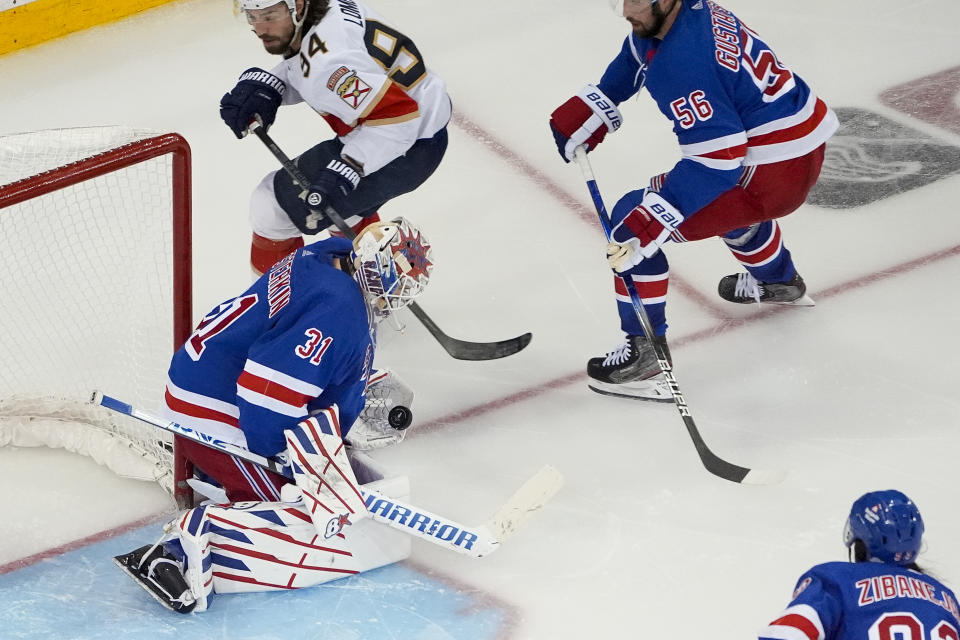 New York Rangers goaltender Igor Shesterkin (31) makes a save on a shot by Florida Panthers left wing Ryan Lomberg (94) in overtime of Game 2 of the Eastern Conference finals during the NHL hockey Stanley Cup playoffs, Friday, May 24, 2024, in New York. (AP Photo/Julia Nikhinson)