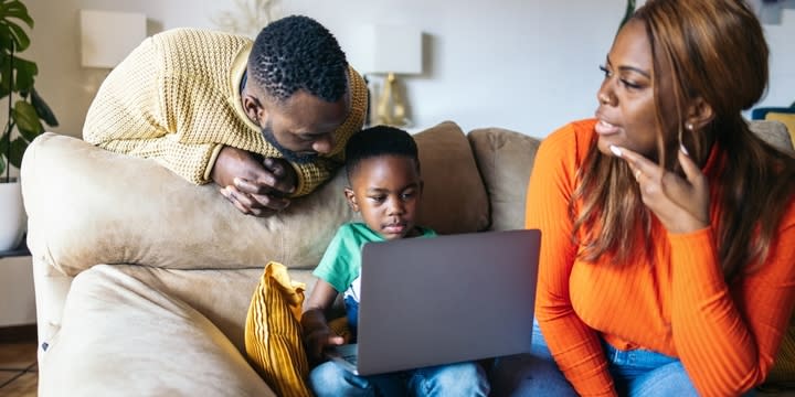 family using laptop at home