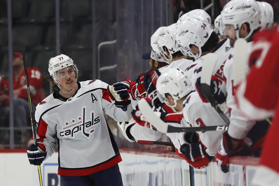 Washington Capitals right wing T.J. Oshie (77) is greeted by teammates after scoring during the second period of an NHL hockey game against the Detroit Red Wings, Saturday, Nov. 30, 2019, in Detroit. (AP Photo/Carlos Osorio)