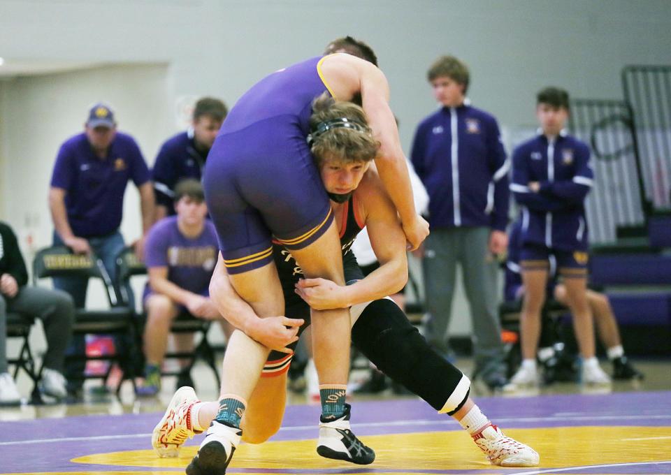 Roland-Story's Logan Powers takes down Nevada's Simon Mills during their 165-pound wrestling match in double-dual meet at the Nevada High School Fieldhouse on Thursday, Dec. 14, 2023, in Nevada, Iowa.