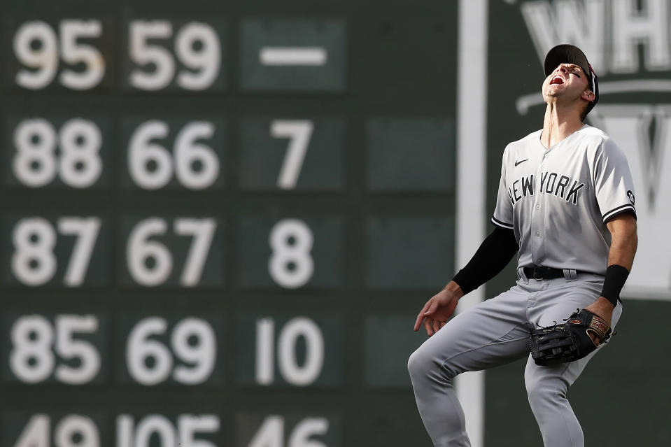 New York Yankees' Joey Gallo looks for the ball in the sun on the fly out by Boston Red Sox's Kyle Schwarber during the second inning of a baseball game, Saturday, Sept. 25, 2021, in Boston. (AP Photo/Michael Dwyer)