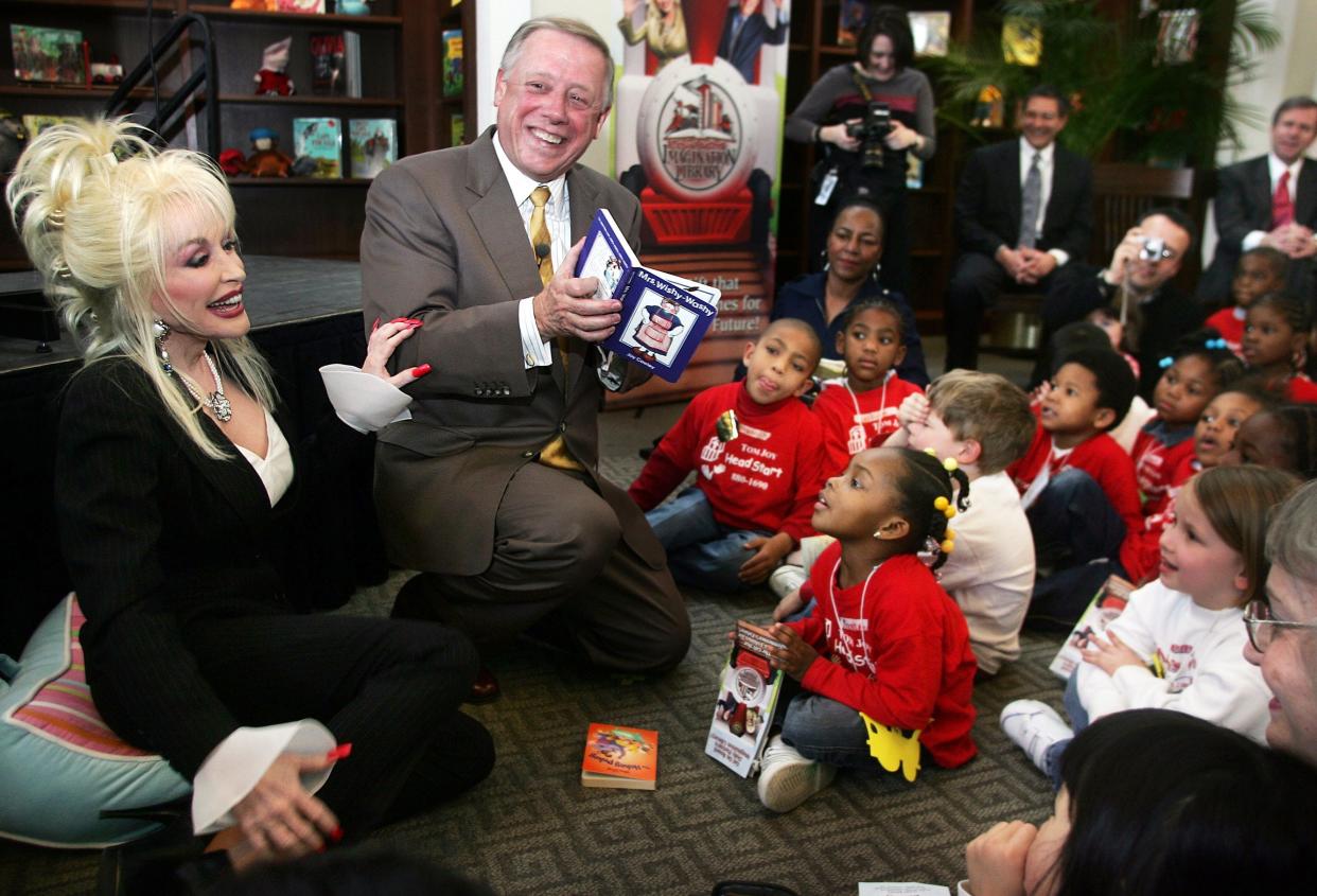 Surprise guest Dolly Parton, left, showed up with Gov. Phil Bredesen, center, and Mayor Purcell to kick off the Imagination library by reading stories to children at the Nashville Main Downtown Library on March 15, 2005.