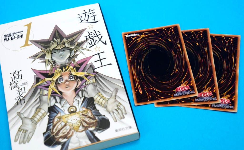 This photo shows “Yu-Gi-Oh!” manga comic and trading cards in Tokyo Thursday, July 7, 2022. Kazuki Takahashi, the creator of the “Yu-Gi-Oh!” manga comic and trading card game, has died. (Shohei Miyano/Kyodo News via AP)