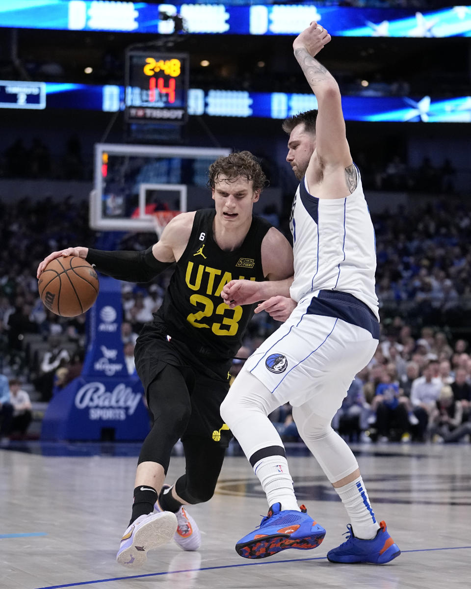 Utah Jazz forward Lauri Markkanen (23) works against Dallas Mavericks' Luka Doncic (77) for a shot in the second half of an NBA basketball game, Tuesday, March 7, 2023, in Dallas. (AP Photo/Tony Gutierrez)