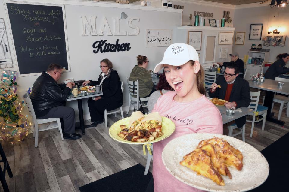 Malissa LaPointe with a Mal's wrap and crunchy French toast dishes at her restaurant Mal's Kitchen, 171 Brockton Ave., unit F, Abington, on Friday, March 17, 2023.