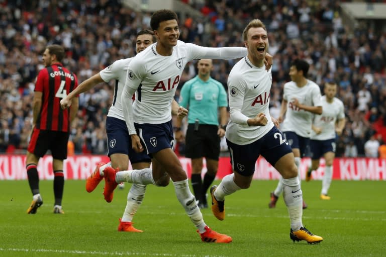 Tottenham Hotspur's Christian Eriksen (R) celebrates with teammate Dele Alli after scoring the team's first goal during their English Premier League match against Bournemouth at Wembley Stadium in London, on October 14, 2017