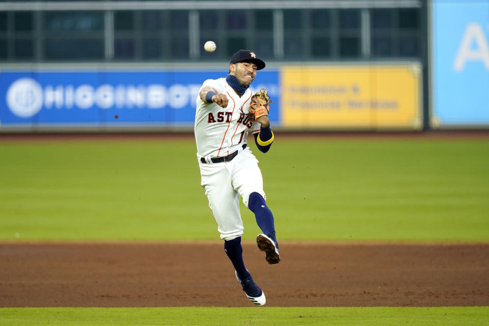 Houston Astros shortstop Carlos Correa throws to first for the out after fielding a ground ball by Texas Rangers' Isiah Kiner-Falefa during the third inning of a baseball game Thursday, Sept. 17, 2020, in Houston. (AP Photo/David J. Phillip)