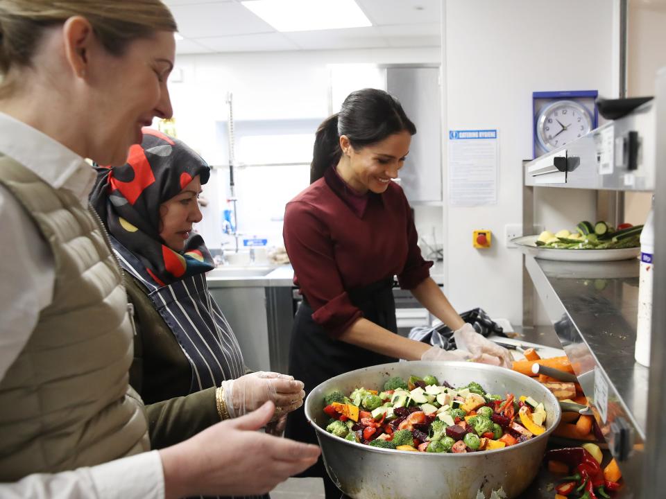 Meghan Markle cooking at a community kitchen.