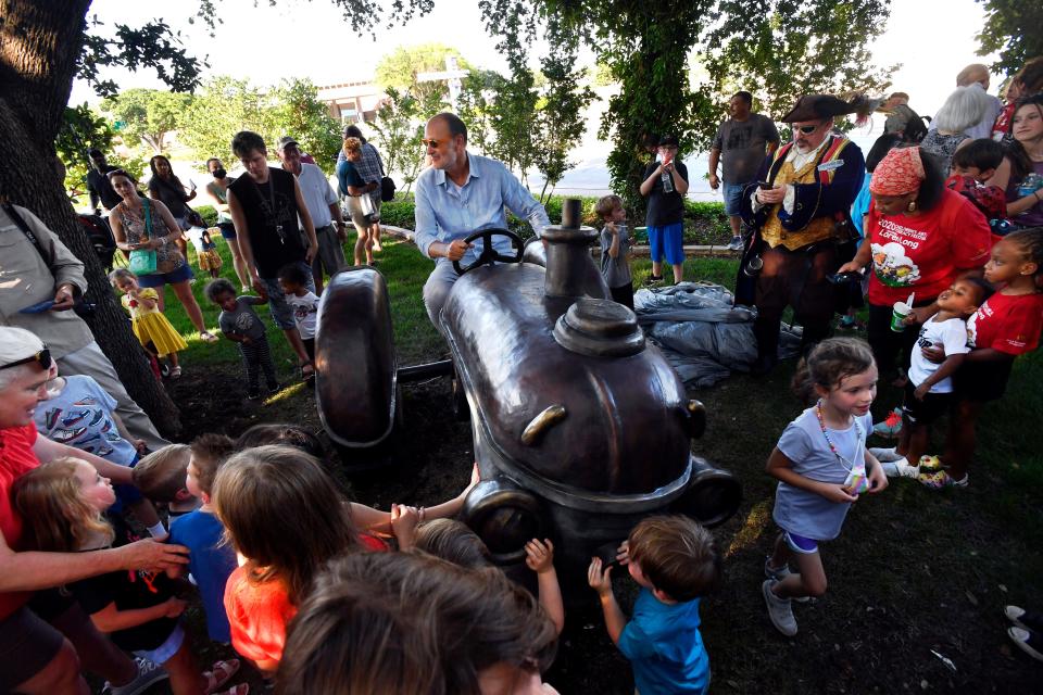 Author and Illustrator Loren Long sits in the seat of the Otis the Tractor sculpture at Adamson-Spalding Storybook Garden on June 10. Sculptor Steve Neves created the work based upon a character from Long's books. Long was the featured author in this year's Children's Art & Literacy Festival.