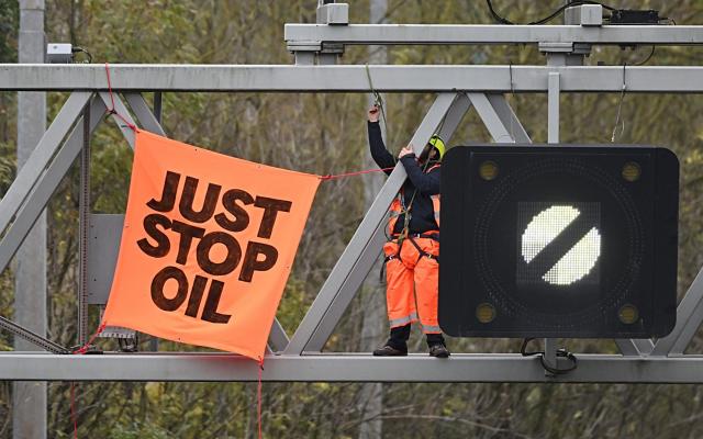 A Just Stop Oil activist climbed a gantry above the M25 last November, causing severe delays - GETTY IMAGES