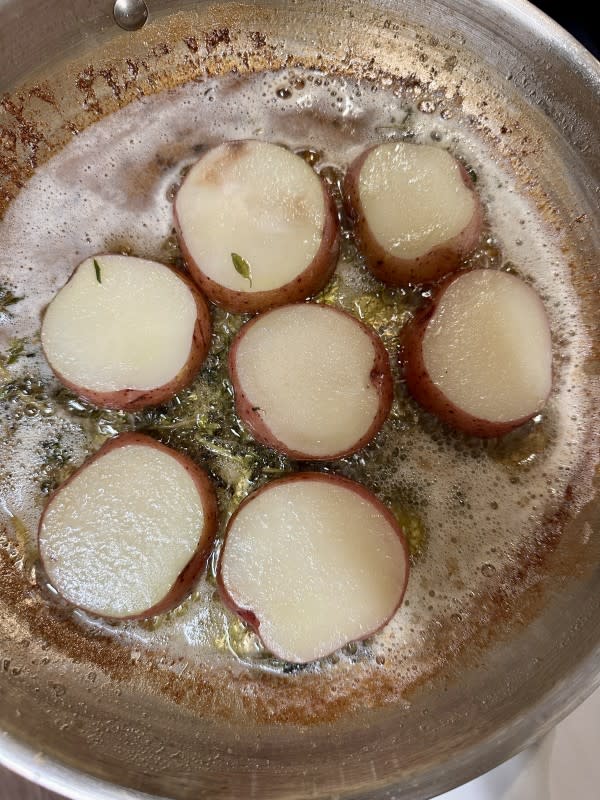 Potatoes bubbling away in butter<p>Kelli Acciardo</p>