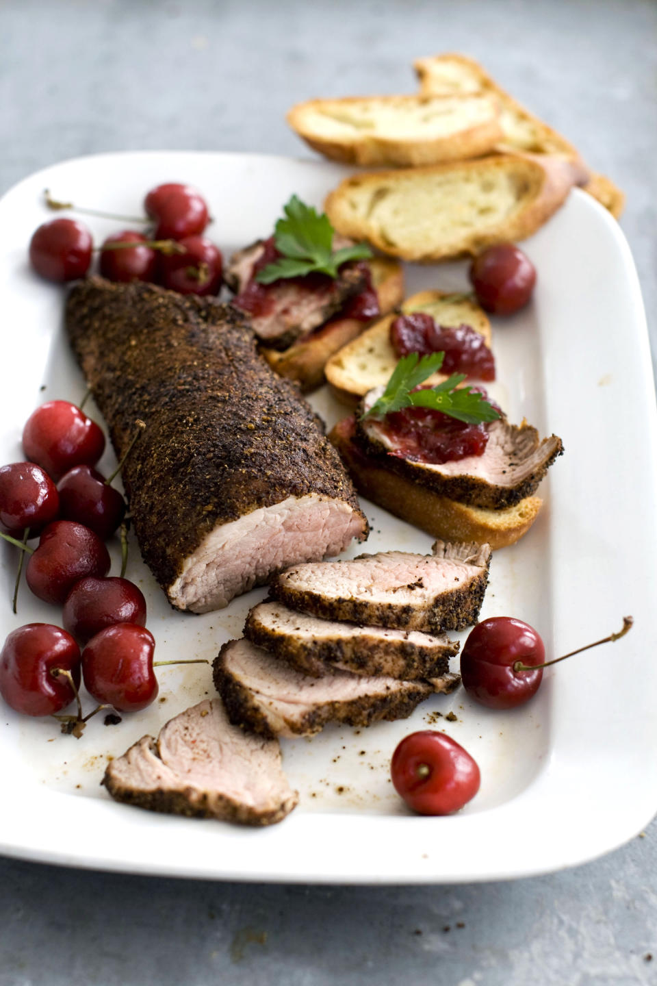In this image taken on Jan. 28, 2013, cherry-topped coffee-roasted pork tenderloin is shown served on a platter in Concord, N.H. (AP Photo: Matthew Mead)