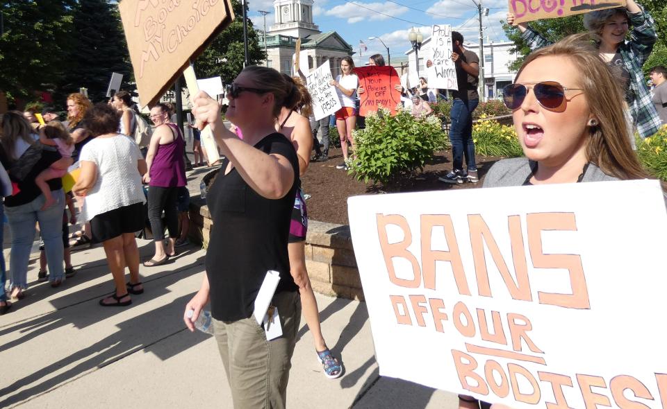 Event organizer Hannah McCoy of Galion, right, chants during a "We Won't Go Back" rally in downtown Bucyrus early Monday evening. Event co-host Courtney Klein of Columbus is at center.