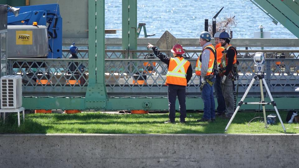 Workers could be seen examining parts of the LaSalle Causeway in Kingston, Ont. on May 9, 2024.