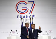 French President Emmanuel Macron and U.S President Donald Trump shake hands during the final press conference during the G7 summit Monday, Aug. 26, 2019 in Biarritz, southwestern France. French President Emmanuel Macron says France and the U.S. have reached a "very good agreement" defusing tensions over a French tax on online giants like Google. (AP Photo/Francois Mori)