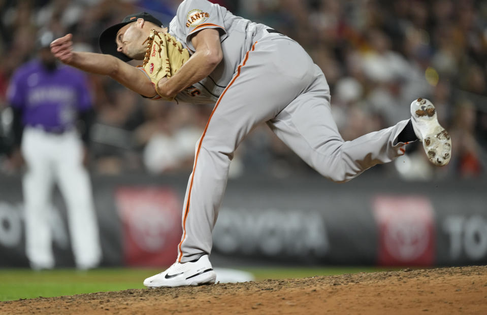 San Francisco Giants relief pitcher Tyler Rogers works against the Colorado Rockies in the eighth inning of a baseball game Friday, Sept. 24, 2021, in Denver. (AP Photo/David Zalubowski)