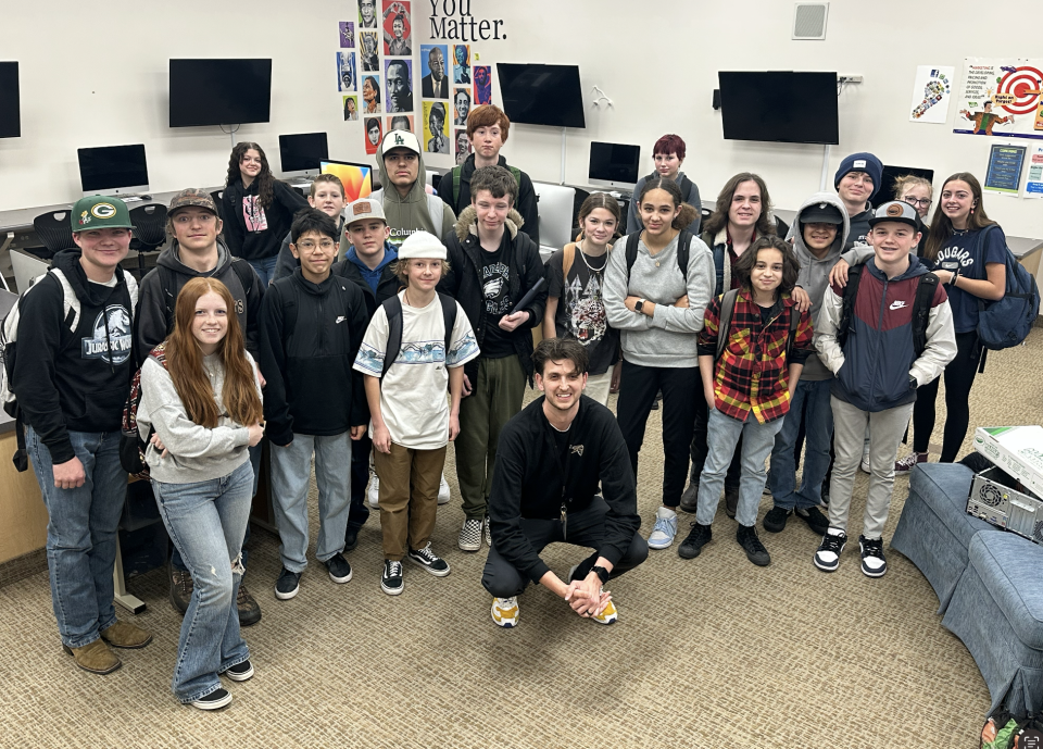 Garrett Jones (center), a Utah middle school teacher of five years, is helping cover the lunch debt of students in the Wasatch County School District after his social media clip requesting $1 donations went viral.