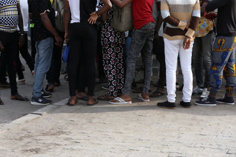 Some of the men charged with public displays of affection with members of the same sex are seen gathered within the premises of the Federal High Court after the court-hearing of their case in Lagos