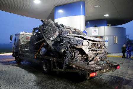 The damaged vehicle that drove over a mine while transporting members of the Organization for Security and Cooperation in Europe (OSCE), who were killed and injured from the incident on Sunday, is seen at a petrol station while it is moved from the scene in Luhansk region, Ukraine, April 23, 2017. REUTERS/Alexander Ermochenko