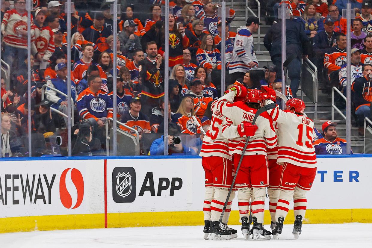 The Calgary Flames celebrate a goal scored by defenseman Noah Hanifin (55).