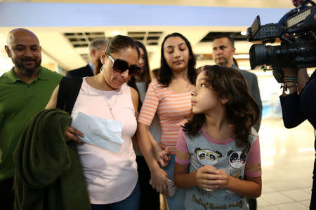 Alejandra Juarez walks with her two daughters, Pamela, 16, and Estela, 9, and her husband, former U.S. Marine Temo Juarez, all U.S. citizens, to the departure gates at Orlando International Airport for her deportation flight to Mexico, in Orlando, Florida, U.S., August 3, 2018. REUTERS/Joey Roulette