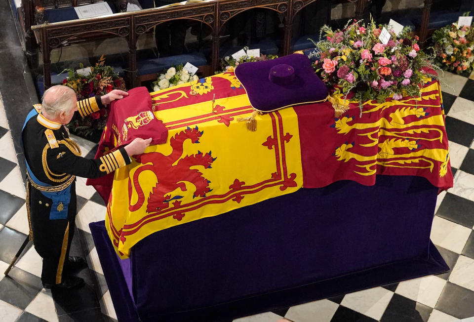 King Charles III places the the Queen's Company Camp Colour of the Grenadier Guards on the coffin at the Committal Service for Queen Elizabeth II, held at St George's Chapel in Windsor Castle, Berkshire. Picture date: Monday September 19, 2022.