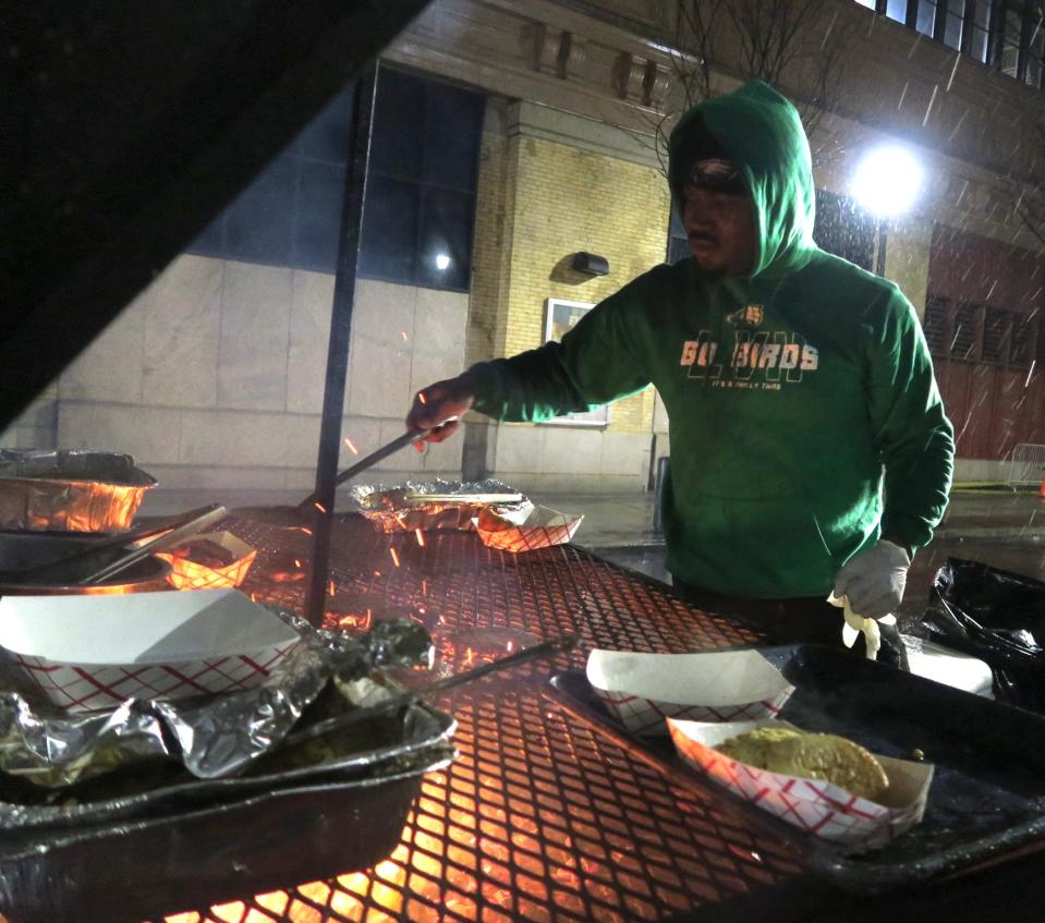 Kamal Rhodes on the BBQ at BBQ clubhouse a self-built barbecue trailer at 12th and Filbert on Sunday, February 12, 2023