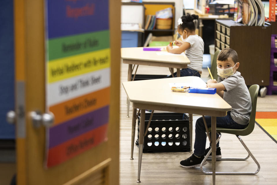 FILE - In this Aug. 27, 2020, file photo, first grade students at Dunmore Elementary Center in Dunmore, Pa., wear face masks on their first day of classes. Moves reflecting takeaways from pandemic experiences are being incorporated into many teacher preparation programs. Digital tools, online instruction, mental and emotional wellness are happening not just in what aspiring educators are learning, but how. More programs are using tools such as computer simulation training and virtual field supervision of student-teaching. (Christopher Dolan/The Times-Tribune via AP)