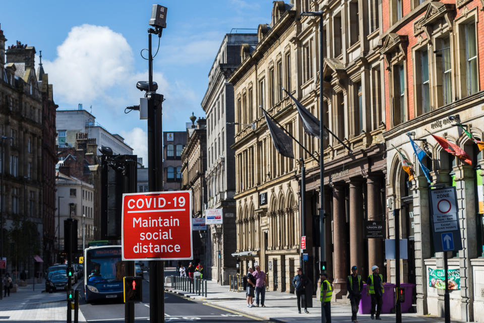 A red road sign reminding people to maintain social distance seen in Liverpool, England in September 2020 during the Covid19 pandemic.