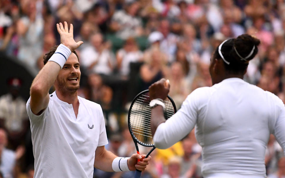 Serena Williams and Andy Murray celebrate winning their mixed doubles match on day eight of the Wimbledon Championships at the All England Lawn Tennis and Croquet Club, Wimbledon.