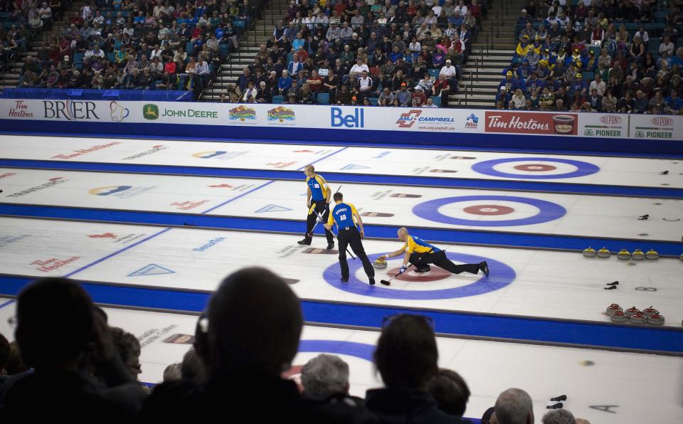 Team Alberta lead Nolan Thiessen delivers a stone in the 3rd end against team British Columbia during the championship draw at the 2014 Tim Hortons Brier curling championships in Kamloops, British Columbia March 9, 2014. REUTERS/Ben Nelms (CANADA - Tags: SPORT CURLING)