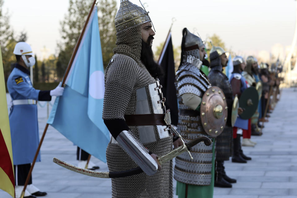 Honour guard members representing 16 former Turkish states stand attention during a ceremony for Spanish Prime Minister Pedro Sanchez at the presidential palace, in Ankara, Turkey, Wednesday, Nov. 17, 2021. (AP Photo/Burhan Ozbilici)