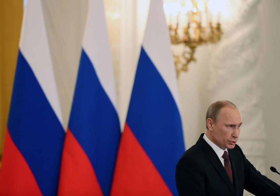 Russia's President Vladimir Putin addresses the Federation Council in Moscow's Kremlin on Tuesday, March 18, 2014. President Vladimir Putin defended Russia’s move to annex Crimea, saying that the rights of ethnic Russians have been abused by the Ukrainian government. He pointed at the example of Kosovo’s independence bid supported by the West, and said that Crimea’s secession from Ukraine repeated Ukraine’s own secession from the Soviet Union in 1991. (AP Photo/Sergei Ilnitsky, pool)