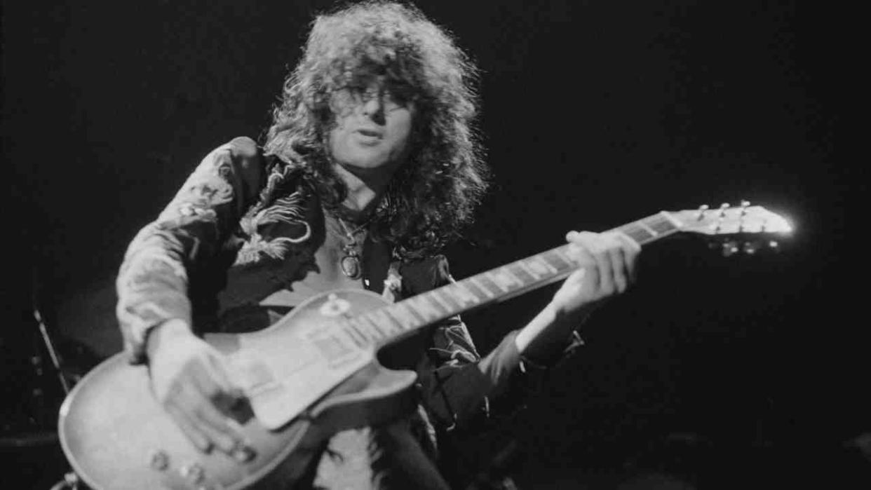  Jimmy Page playing guitar onstage in the 1970s. 