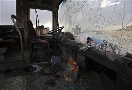 Bloodstains are seen amidst shattered glass inside a minibus which was hit by a suicide attacker in Kabul May 26, 2014. REUTERS/Omar Sobhani