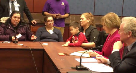 Government employees affected by the partial U.S. government shutdown speaks at a meeting in Washington D.C., U.S., January 18, 2019, in this still image taken from a video obtained from social media. Maria Ponce iAmerica Action/SEIU/via REUTERS