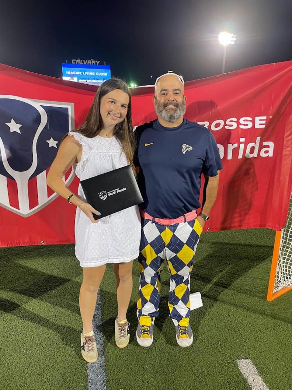 Sydney Powell of Palmer Trinity School, pictured with Coach Jose Herrera, was named USA Lacrosse Academic All-American for the Florida-South Atlantic area. Photo Courtesy Palmer Trinity Lacrosse