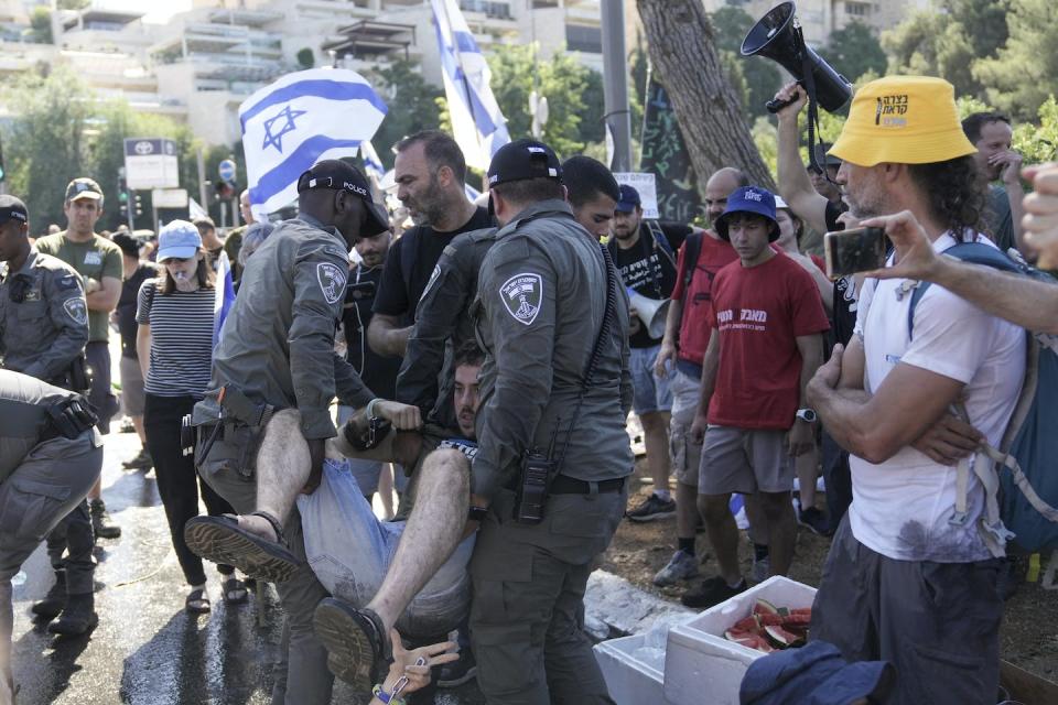 Israeli police disperse demonstrators blocking the entrance to Israel’s parliament during a July 24, 2023, protest in Jerusalem against plans to overhaul the judicial system. <a href="https://newsroom.ap.org/detail/IsraelPolitics/8a329a7f939e4b63a46884e1d58e072a/photo?Query=Knesset&mediaType=photo&sortBy=arrivaldatetime:desc&dateRange=Anytime&totalCount=1732&currentItemNo=36" rel="nofollow noopener" target="_blank" data-ylk="slk:AP Photo/Mahmoud Illean;elm:context_link;itc:0;sec:content-canvas" class="link ">AP Photo/Mahmoud Illean</a>