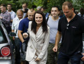 Sviatlana Tsikhanouskaya, candidate for the presidential elections, center, walks surrounded by her supporters after voting at a polling station during the presidential election in Minsk, Belarus, Sunday, Aug. 9, 2020. Belarusians are voting on whether to grant incumbent president Alexander Lukashenko a sixth term in office, extending his 26-years rule, following a campaign marked by unusually strong demonstrations by opposition supporters. (AP Photo/Sergei Grits)