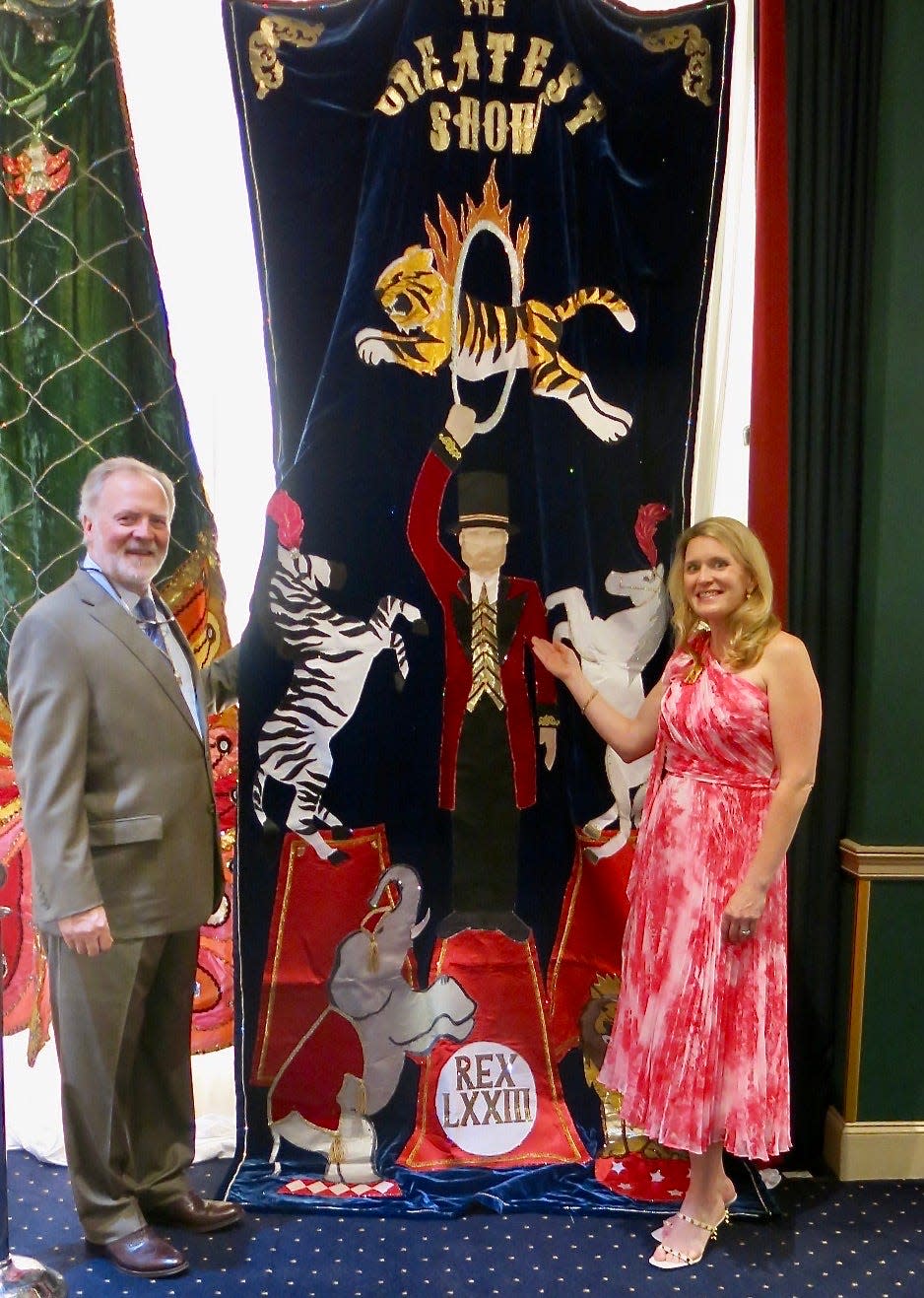 Mark Pollard Sealy, who was Rex LXXIII, and Lila Knicely, who was co-chair during Sealy's reign, pose with the train that Rex LXIII wore during the ball that year.