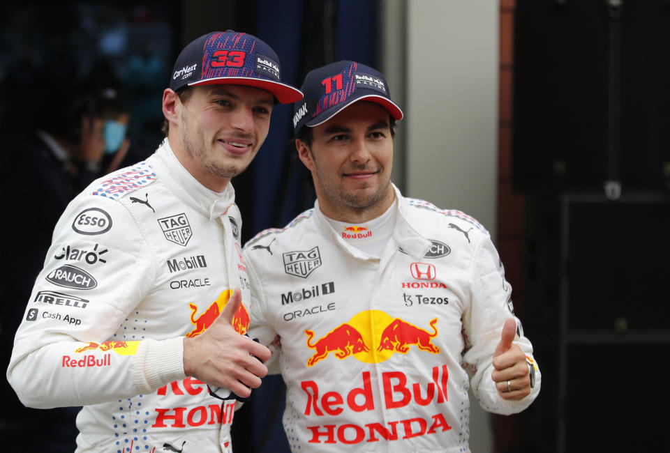 Second placed Red Bull driver Max Verstappen of the Netherlands, left, and third placed Red Bull driver Sergio Perez of Mexico pose after the Turkish Formula One Grand Prix at the Intercity Istanbul Park circuit in Istanbul, Turkey, Sunday, Oct. 10, 2021. (Umit Bektas/Pool via AP)