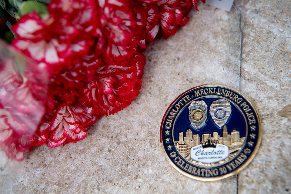 Flowers were laid on the stairway leading to the Charlotte-Mecklenburg Police Department, April 30, 2024, the day after four law enforcement officers were killed and four others were injured when gunfire erupted as authorities attempted to serve a warrant in Charlotte, North Carolina.