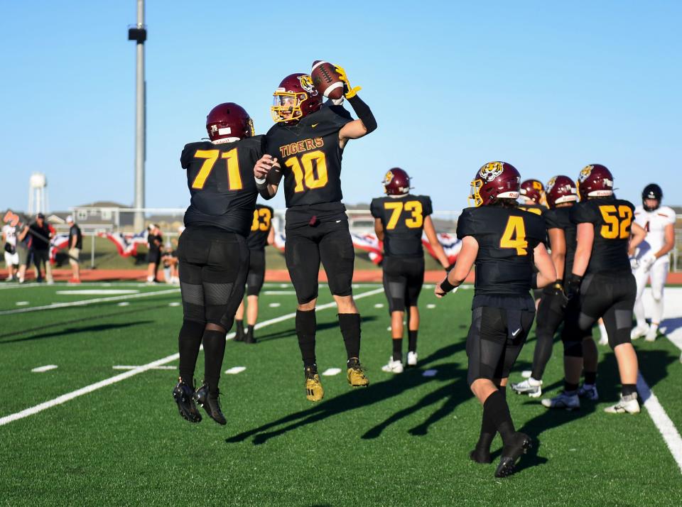 Harrisburg players celebrate a touchdown on Friday, September 2, 2022, at Harrisburg High School.