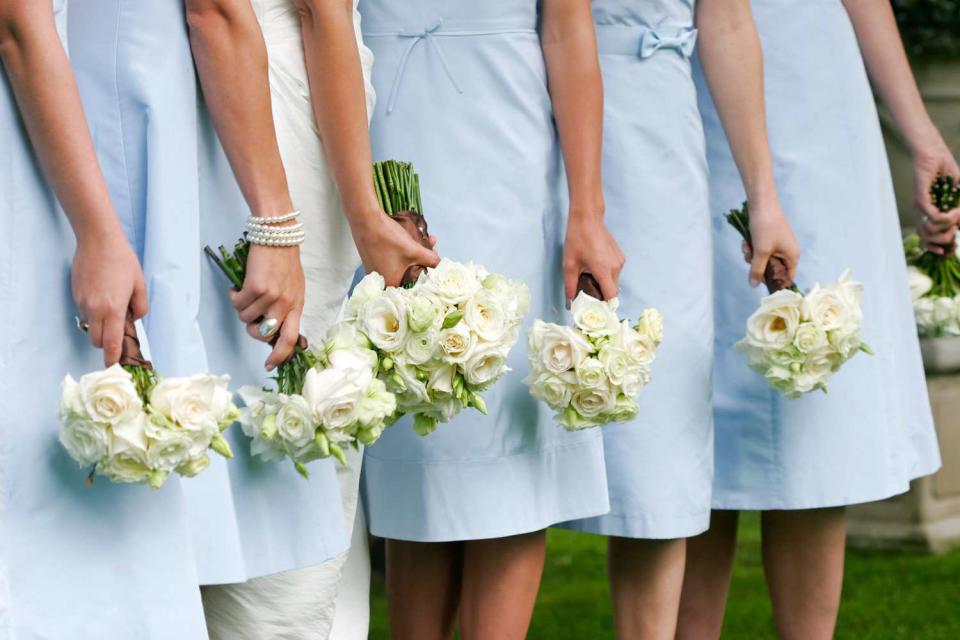 <p>Getty</p> bridesmaids with floral bouquets