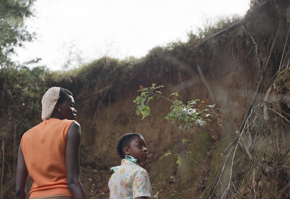 This image released by A24 shows Kaylee Nicole Johnson, right, and Sheila Atim in a scene from "All Dirt Roads Taste of Salt." (A24 via AP)