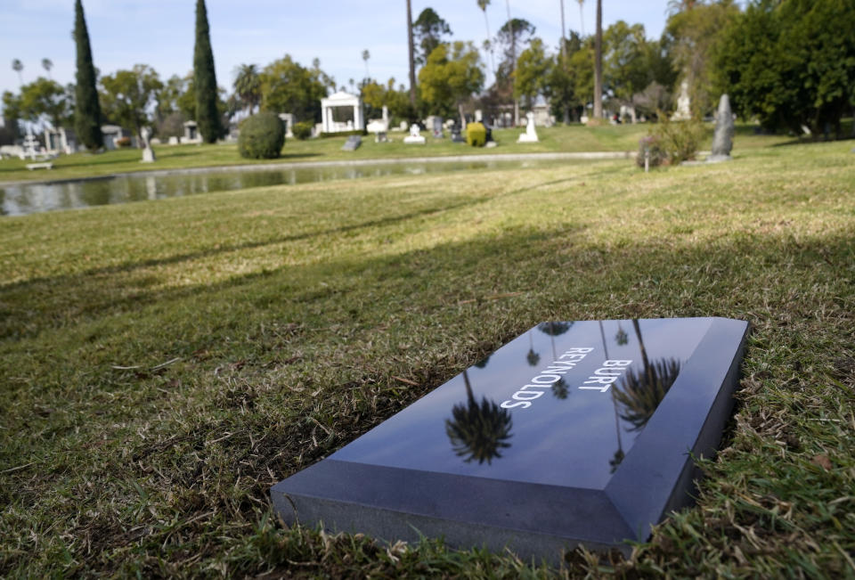 A temporary headstone for the late actor Burt Reynolds is pictured in the Garden of Legends section of Hollywood Forever cemetery, Thursday, Feb. 11, 2021, in Los Angeles. Reynolds' cremated remains were moved from Florida to Hollywood Forever, where a small ceremony was held Thursday. A permanent gravesite will be put up for Reynolds in a few months. (AP Photo/Chris Pizzello)
