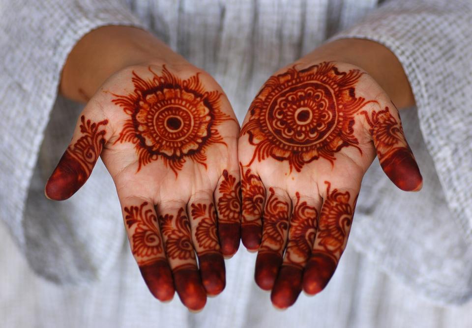 Girl displaying her Mehndi (henna) on occasion of Islamic festival of Eid-ul-Azha, celebrated after Hajj at Makkah Sharif.