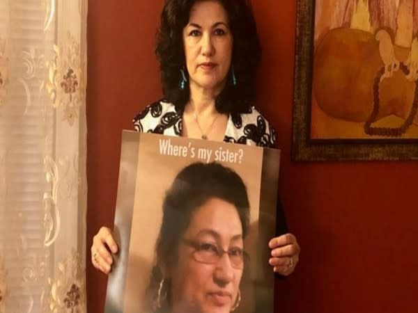 Activist Rushan Abbas with a poster of her sister, Gulshan Abbas.