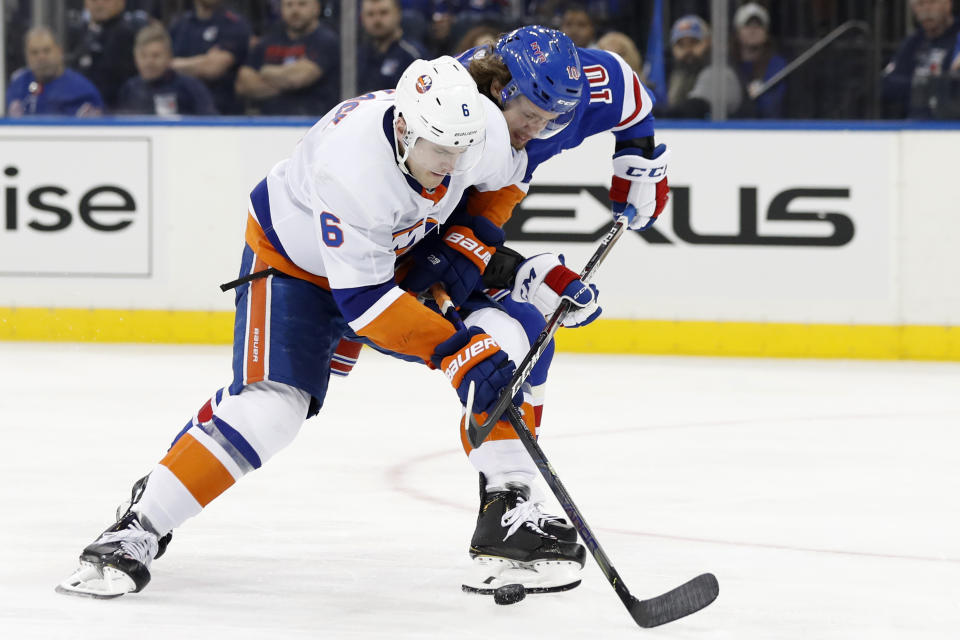 New York Islanders defenseman Ryan Pulock (6) tries to fend off New York Rangers left wing Artemi Panarin (10) during the second period of an NHL hockey game, Monday, Jan. 13, 2020, in New York. (AP Photo/Kathy Willens)