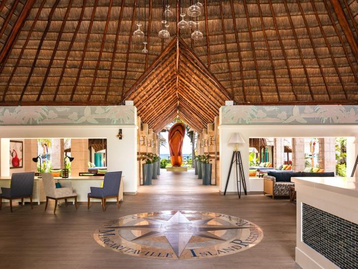 The lobby of the Margaritaville Island Reserve Riviera Cancun in Mexico with a giant flip-flop at the end of an open hallway